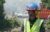Wayne Reece manages traffic during the 3rd day of the 6th alarm building fire at Southdown Freezing Works
